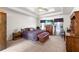Spacious main bedroom with a tray ceiling, carpet floors, and large windows at 1800 Rockdale Cir, Snellville, GA 30078