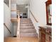 View of the carpeted stairs leading to the upper level; classic wooden handrail and trim at 1800 Rockdale Cir, Snellville, GA 30078