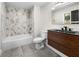 Bathroom featuring modern vanity, shower with marble accent wall, and gray tile floors at 2751 Margaret Mitchell Nw Dr, Atlanta, GA 30327