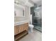 Bathroom with marble countertop, gold hardware, lighted mirror and glass shower with marble and glass accents at 2751 Margaret Mitchell Nw Dr, Atlanta, GA 30327