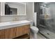 Modern bathroom featuring sleek vanity, a lighted mirror, and a glass-enclosed shower with a rainfall showerhead at 2751 Margaret Mitchell Nw Dr, Atlanta, GA 30327