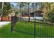 View of home showcasing its modern architectural style, a gated entrance, and a well-maintained lawn at 2751 Margaret Mitchell Nw Dr, Atlanta, GA 30327