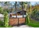 Stylish modern home exterior featuring a wooden fence, unique architecture, and lush green surroundings at 2751 Margaret Mitchell Nw Dr, Atlanta, GA 30327