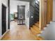 Modern foyer showcasing wood floors, sleek staircase design, and an inviting living area at 2751 Margaret Mitchell Nw Dr, Atlanta, GA 30327