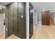 Inviting hallway with hardwood floors, paneled walls, and wooden slatted accent wall leading to the stairway at 2751 Margaret Mitchell Nw Dr, Atlanta, GA 30327