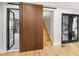 Hallway with modern design elements, including a sliding wood door and glass partition at 2751 Margaret Mitchell Nw Dr, Atlanta, GA 30327