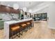 Modern kitchen boasts a marble waterfall island, stainless steel appliances, and designer lighting at 2751 Margaret Mitchell Nw Dr, Atlanta, GA 30327