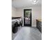 Laundry room featuring a gray tile floor, black trimmed door and gray cabinetry at 2751 Margaret Mitchell Nw Dr, Atlanta, GA 30327