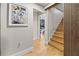 Contemporary staircase with hardwood steps and decorative wall art leading to a bedroom at 2751 Margaret Mitchell Nw Dr, Atlanta, GA 30327