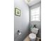 Powder room with a white toilet and modern fixtures at 935 Sunset Ridge Ln, Lawrenceville, GA 30045
