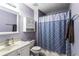 Bathroom showcasing a vanity, toilet, and bathtub with a star-patterned shower curtain at 935 Sunset Ridge Ln, Lawrenceville, GA 30045