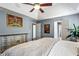 Bright bedroom showcasing a ceiling fan, hardwood floors, and ensuite bathroom access at 935 Sunset Ridge Ln, Lawrenceville, GA 30045