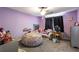 Cozy bedroom featuring carpet, purple walls, and a comfortable beanbag chair at 935 Sunset Ridge Ln, Lawrenceville, GA 30045