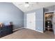 This bedroom has blue walls, a ceiling fan, and a closet at 935 Sunset Ridge Ln, Lawrenceville, GA 30045