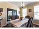 Traditional dining room with a stylish chandelier, large window, and seating for six around the dining table at 935 Sunset Ridge Ln, Lawrenceville, GA 30045