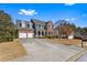 Beautiful brick home with a spacious driveway and well-manicured lawn at 935 Sunset Ridge Ln, Lawrenceville, GA 30045