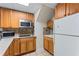 A compact kitchen with light wood cabinets and a tile backsplash at 935 Sunset Ridge Ln, Lawrenceville, GA 30045