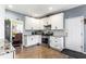 Clean kitchen with white cabinets, granite counters, stainless steel appliances, and tile flooring at 935 Sunset Ridge Ln, Lawrenceville, GA 30045