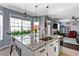 Stylish kitchen island features granite countertops, a sink, and ample counter space with an open living area at 935 Sunset Ridge Ln, Lawrenceville, GA 30045