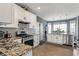 Well-lit kitchen with granite countertops, subway tile backsplash, and stainless steel appliances at 935 Sunset Ridge Ln, Lawrenceville, GA 30045