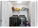Laundry closet features machines and storage shelves at 935 Sunset Ridge Ln, Lawrenceville, GA 30045