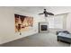 Neutral room featuring a fan, fireplace, and tapestry at 935 Sunset Ridge Ln, Lawrenceville, GA 30045