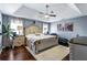 Spacious main bedroom with a tray ceiling, a ceiling fan, and coordinating furniture at 935 Sunset Ridge Ln, Lawrenceville, GA 30045