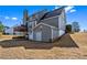 Rear view of a two-story home with a spacious backyard and a deck at 935 Sunset Ridge Ln, Lawrenceville, GA 30045
