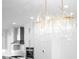 Modern chandelier with decorative pendants over white kitchen cabinetry, oven, and range hood at 245 Mayfair Ct, Alpharetta, GA 30009