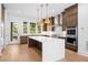 Warm kitchen features an island, stainless steel appliances, and access to the backyard at 245 Mayfair Ct, Alpharetta, GA 30009