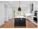 Spacious kitchen boasts a dark island, stainless steel appliances, and hardwood floors at 245 Mayfair Ct, Alpharetta, GA 30009