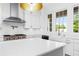 Bright white kitchen with a large island, stainless steel appliances, and herringbone backsplash at 245 Mayfair Ct, Alpharetta, GA 30009