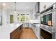 Bright, modern kitchen with white cabinets, stainless steel appliances, and a large center island at 245 Mayfair Ct, Alpharetta, GA 30009