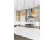 Bright kitchen featuring stainless steel appliances, a gas cooktop, subway tile backsplash, and a large center island at 245 Mayfair Ct, Alpharetta, GA 30009