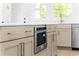 Kitchen island with light brown cabinetry, white countertops, and stainless steel appliances at 245 Mayfair Ct, Alpharetta, GA 30009