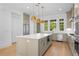 Elegant kitchen with a large center island, stainless steel appliances, and pendant lighting fixtures at 245 Mayfair Ct, Alpharetta, GA 30009