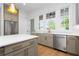 Well-lit kitchen featuring stainless steel appliances, a light brown island, and a view to the outdoor scenery at 245 Mayfair Ct, Alpharetta, GA 30009
