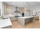 Bright, spacious kitchen featuring stainless steel appliances, subway tile backsplash, and a large center island with pendant lighting at 245 Mayfair Ct, Alpharetta, GA 30009