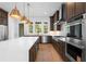 Warm kitchen features an island, stainless steel appliances, and lots of windows at 245 Mayfair Ct, Alpharetta, GA 30009
