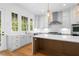 Bright kitchen featuring an island with wood accents, stainless appliances, and stylish pendant lighting at 245 Mayfair Ct, Alpharetta, GA 30009
