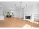 Expansive open-concept space showing the kitchen, living area with fireplace, and hardwood flooring at 245 Mayfair Ct, Alpharetta, GA 30009