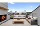 Cozy outdoor patio with a fireplace, comfortable seating and neighborhood views at 245 Mayfair Ct, Alpharetta, GA 30009