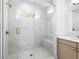 Modern shower with glass door, white subway tile and gold fixtures at 245 Mayfair Ct, Alpharetta, GA 30009