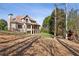 Large private backyard showcasing mature trees and a two-story brick home at 5640 Copper Creek Pass, Cumming, GA 30040