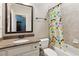 Bathroom with a granite countertop vanity and shower-tub combo with a whimsical shower curtain at 5640 Copper Creek Pass, Cumming, GA 30040
