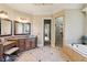 Luxury bathroom features double vanities, large soaking tub, and a separate glass shower at 5640 Copper Creek Pass, Cumming, GA 30040