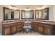 Large bathroom boasts dual sinks with granite countertops and decorative framed mirrors at 5640 Copper Creek Pass, Cumming, GA 30040