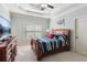 Bedroom with a wooden bed, light blue walls, a window with shutters, and an elegant dresser at 5640 Copper Creek Pass, Cumming, GA 30040