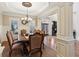 Charming dining room featuring decorative molding, hardwood floors, and large windows at 5640 Copper Creek Pass, Cumming, GA 30040