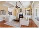 Cozy living room featuring a fireplace, custom built-ins, and large windows for natural light at 5640 Copper Creek Pass, Cumming, GA 30040